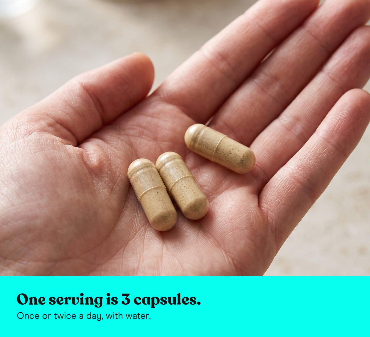 Three Chaga extract capsules in an open hand: one serving is 3 capsules, once or twice a day, with water
